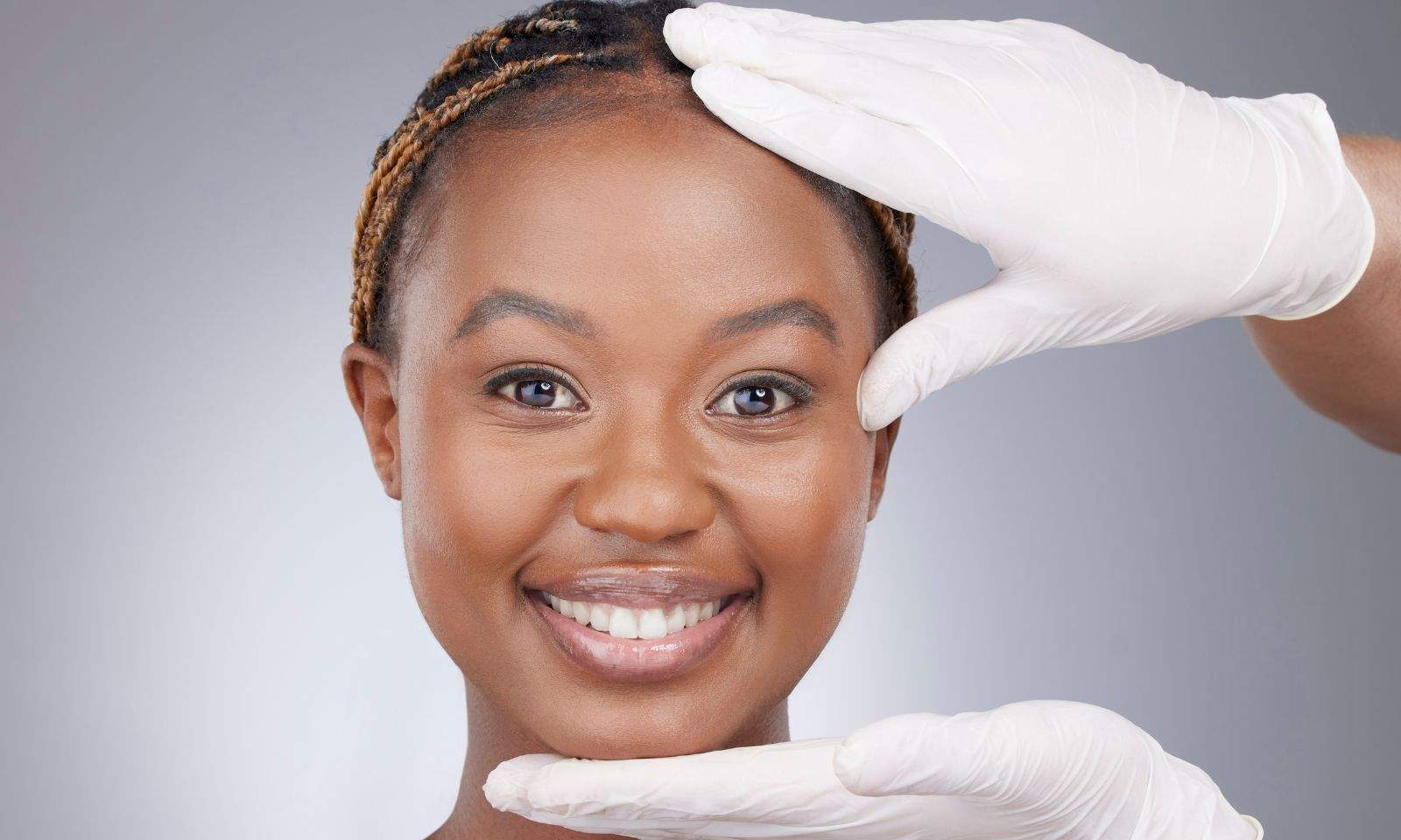 woman smiling thanks to her recent plastic surgery procedures